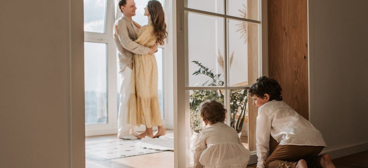 A joyful family moment indoors with parents and children enjoying a cozy home environment.