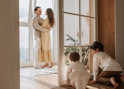 A joyful family moment indoors with parents and children enjoying a cozy home environment.